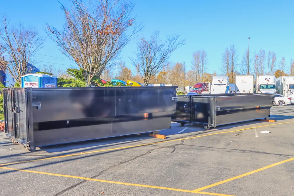Professional dumpster rental service with roll-off container on residential driveway in Frostburg